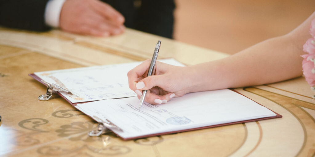 a client signing documents during an initial consultation with her attorney