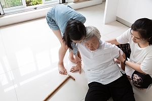 Asian family helps their grandma off the ground after a fall