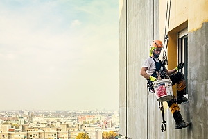 window cleaner washes windows on high rise building