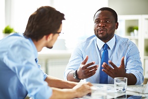 attorney and client sitting down and discussing case in an office