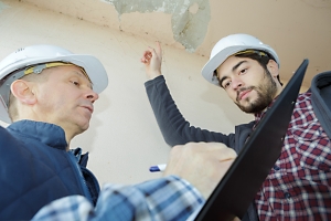 construction workers reviewing defective construction