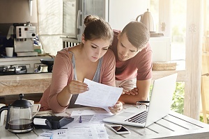 couple reviewing insurance bad faith claims paperwork in their kitchen