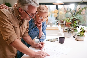 couple reviewing personal guarantee paperwork in their home