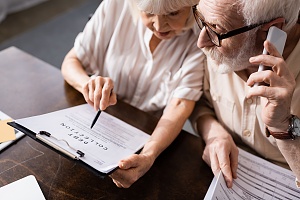 older couple on the phone with a debt collection law professional