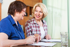 two women signing personal guarantee paperwork