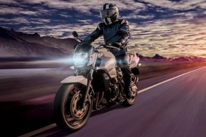 biker riding motorcycle during sunset