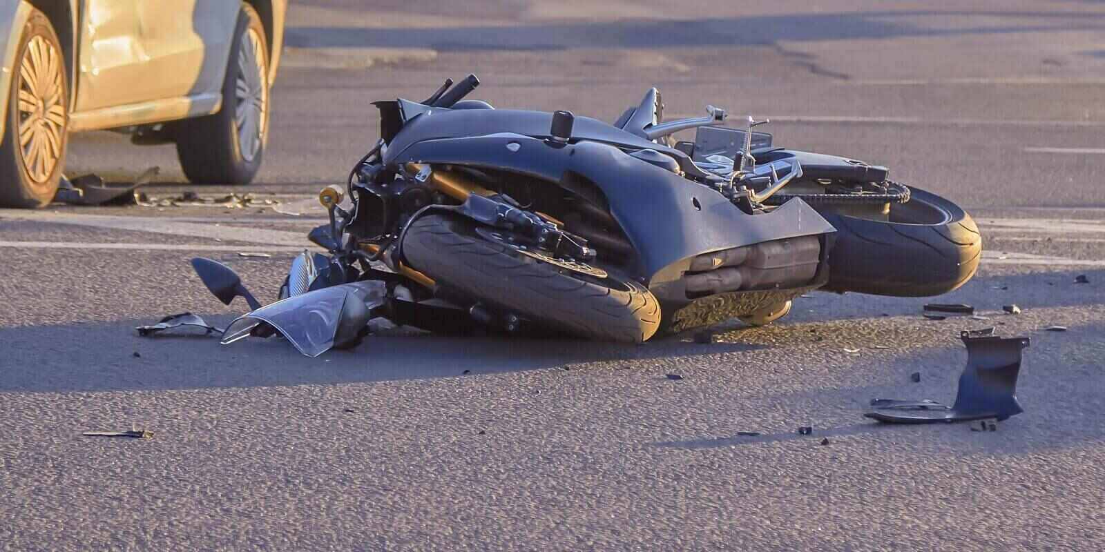 motobike crashed into a car a motorcyclist