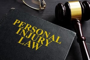 personal injury law book with judge gavel