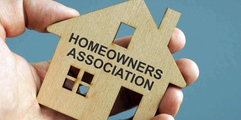 homeowners association hoa written on a model of home
