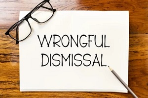 wrongful dismissal on big note with specs and pencil