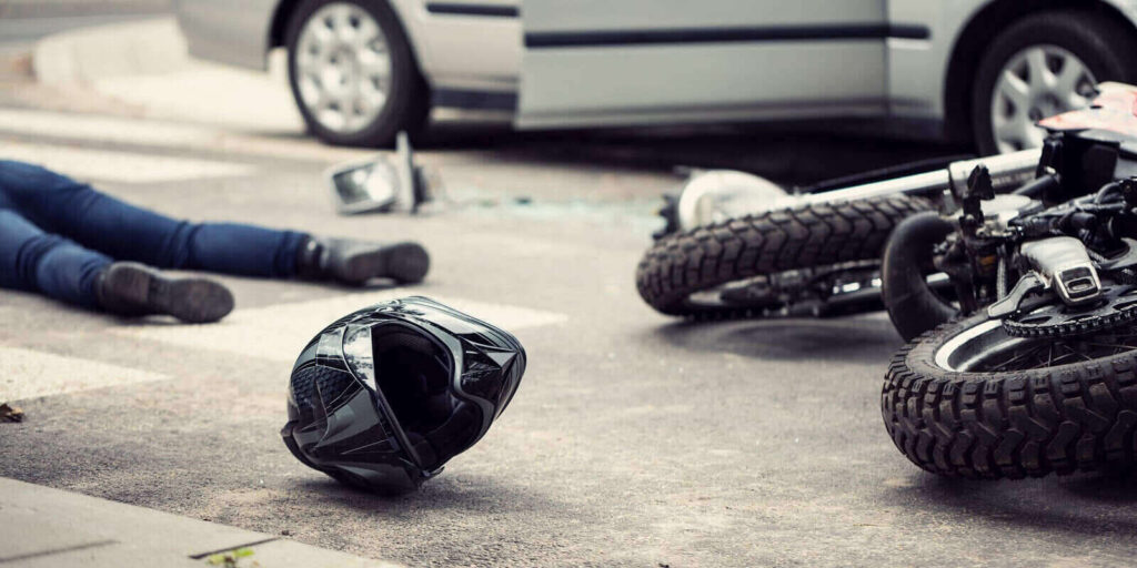 black helmet and motorcycle after dangerous traffic incident with car on the street in California