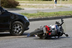 crash motor bike and car on road